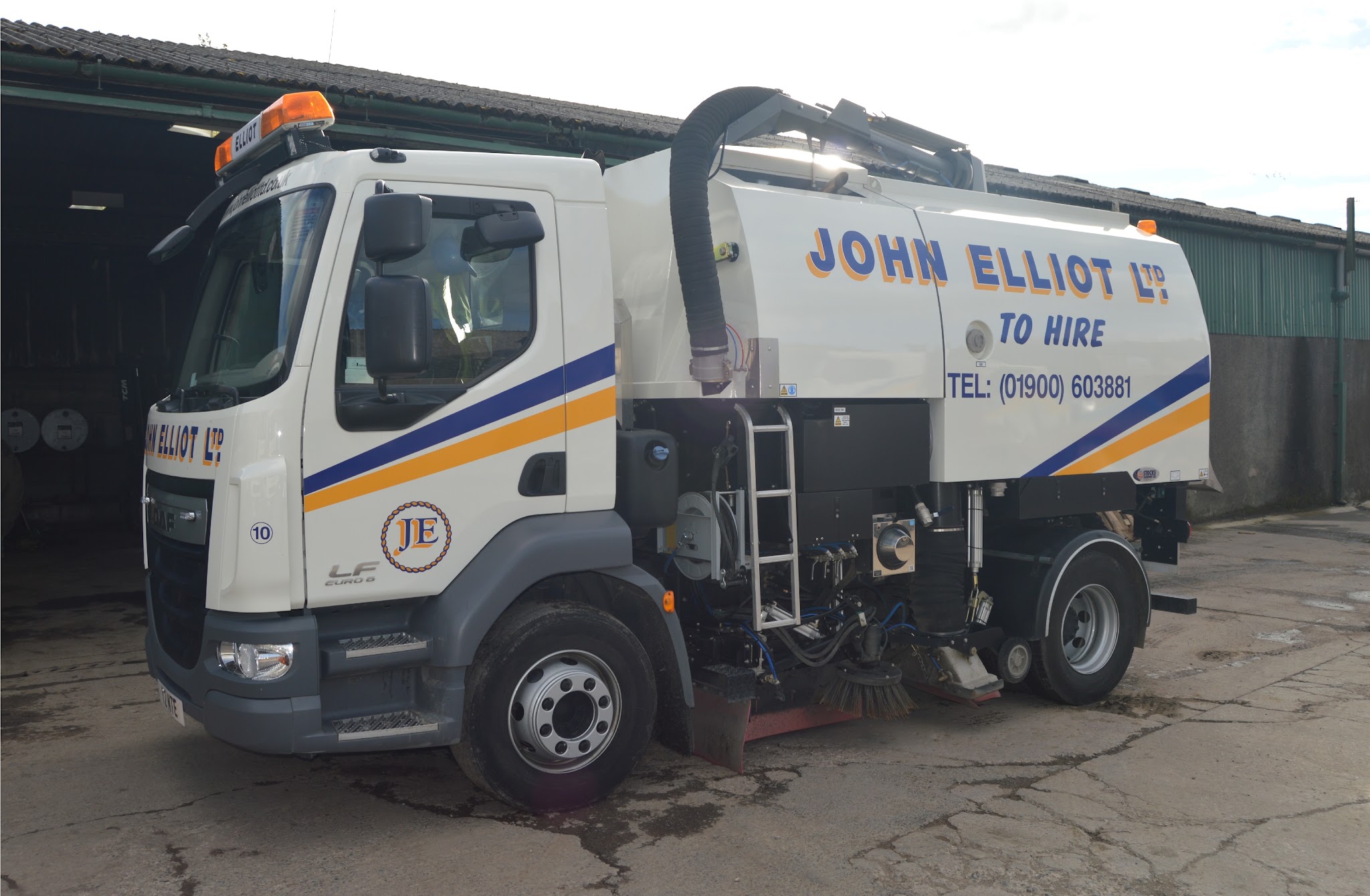 White DAF road sweeper lettered John Elliot Ltd To Hire with navy and orange stripes