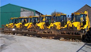 Line of yellow JCB backhoe loaders