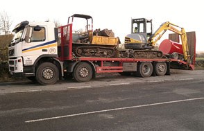 Low loader carrying two mini excavators and a dumper